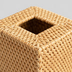 Close up of the woven rim around the top opening of the natural rattan cube tissue box cover.