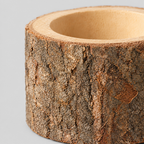 Close up of the rough tree bark surface texture of the natural bark stump candle holder.
