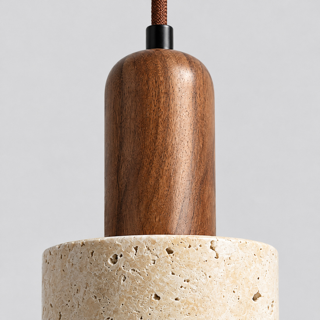 Close up of the seam where the walnut socket cap meets the travertine cylinder of the yellow travertine pendant light.