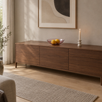 Blush shallow glass bowl on a 160 cm wide walnut sideboard with three lemons in the bowl.