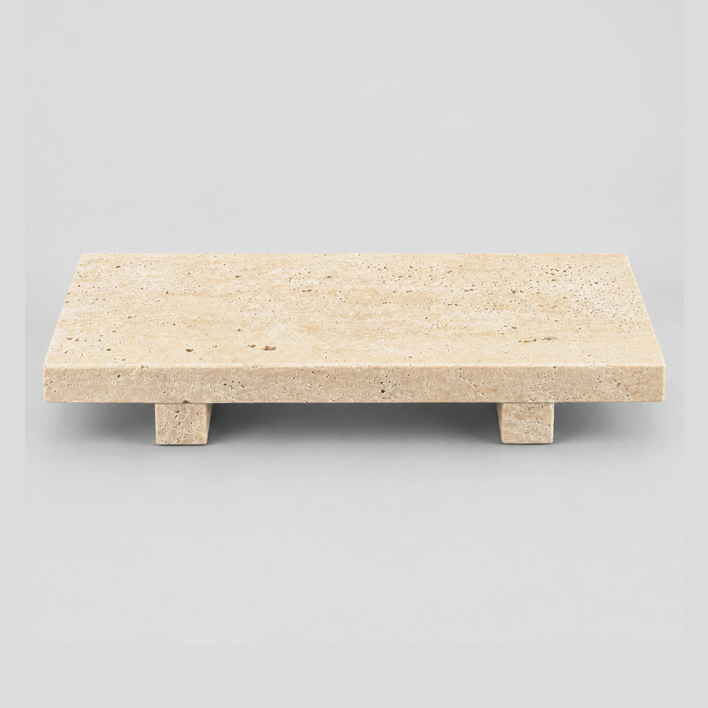 Footed rectangular travertine tray in Beige Travertine on a light gray studio background