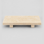 Footed rectangular travertine tray in Beige Travertine on a light gray studio background