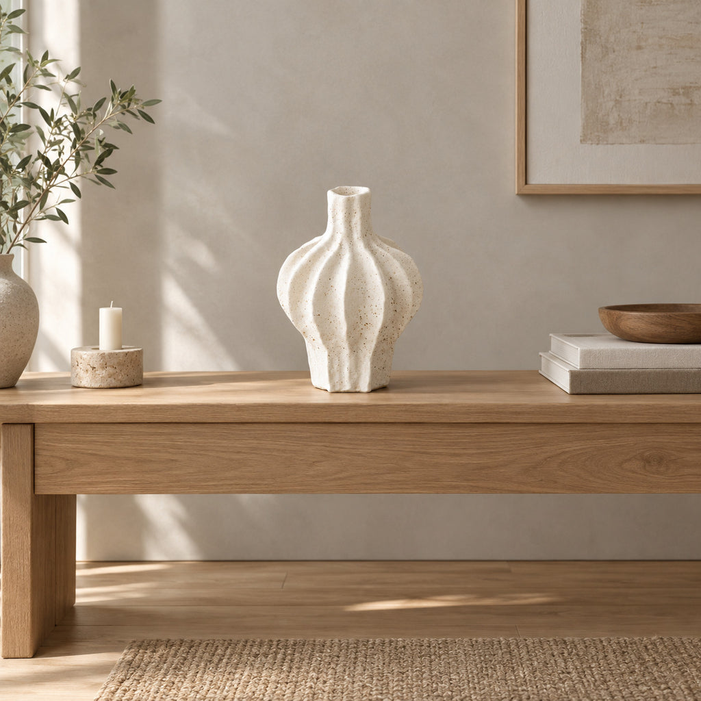 Coarse ceramic fluted vase in Speckled White on an oak console table in a calm room.