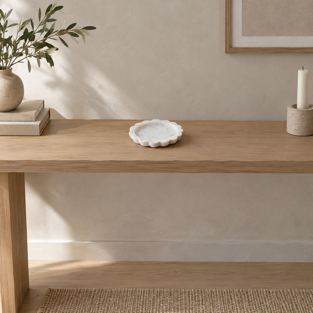 Scalloped stone trinket tray in White Marble on a 120 cm wide oak console table in a calm room.