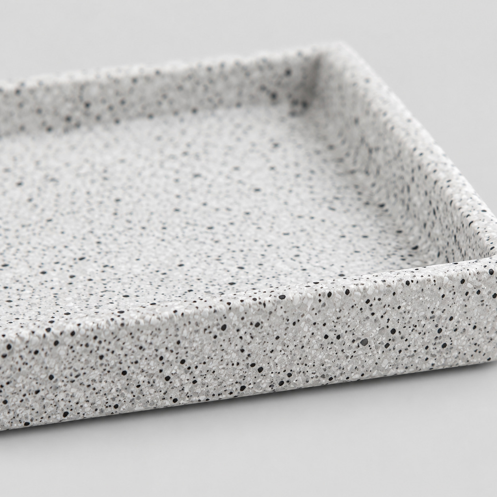 Close up of the speckled snowflake glaze on the ceramic surface of the speckled ceramic catchall tray in Speckled White.