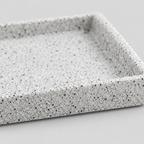 Close up of the speckled snowflake glaze on the ceramic surface of the speckled ceramic catchall tray in Speckled White.