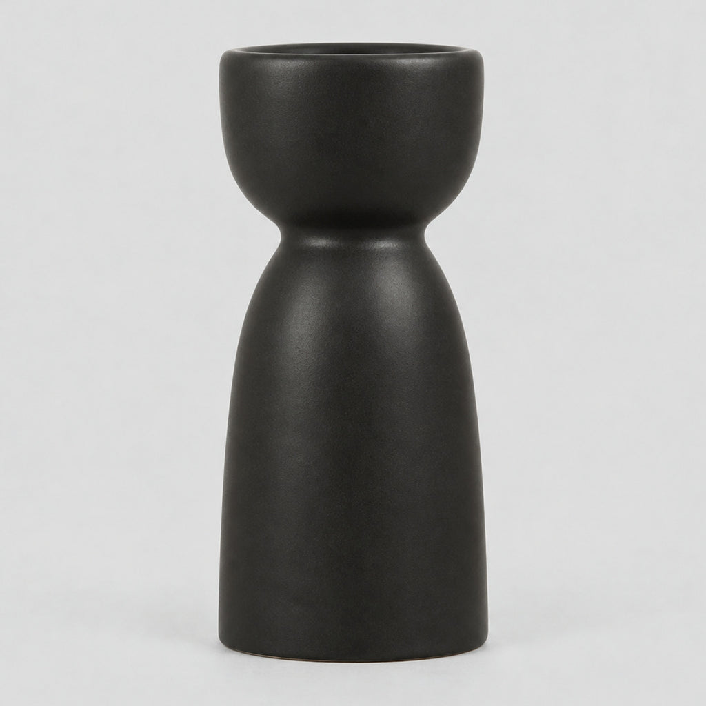 Matte ceramic taper candle holder in Matte Black on a light gray studio background.