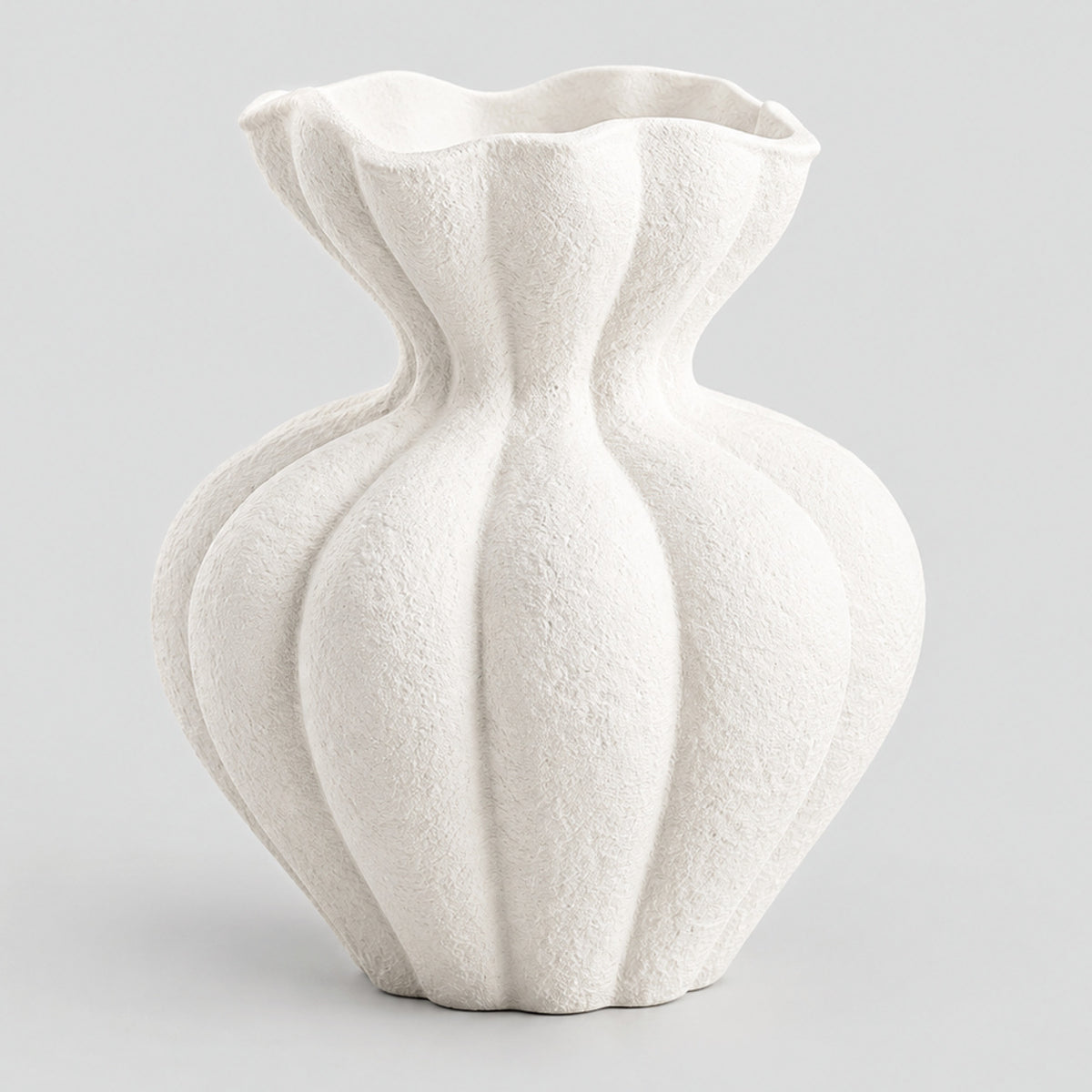 Textured matte white ceramic vase in Matte White on a light gray studio background.