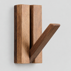 Natural Acacia fold-down wooden coat hook on a light gray studio background
