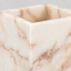 Close up of the honed marble surface texture of the square marble candle holder.