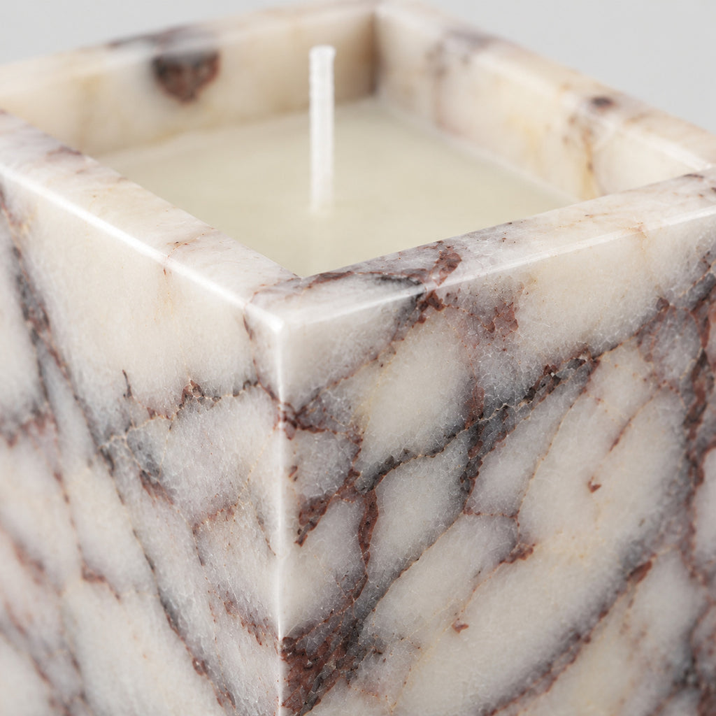 Close up of the mitered corner joint of the Calacatta Viola square marble candle holder.