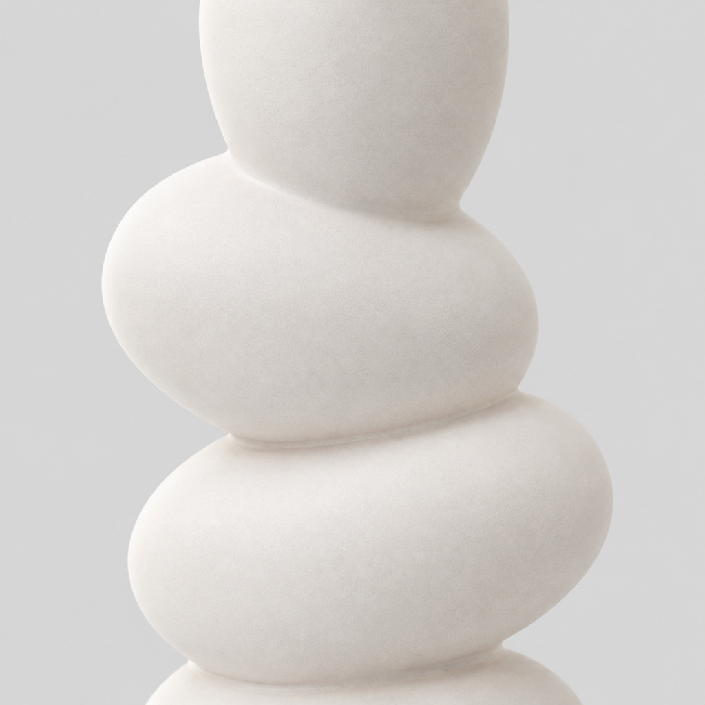 Close up of the smooth matte glaze across the rounded pebble tiers of the white stacked pebble ceramic vase.