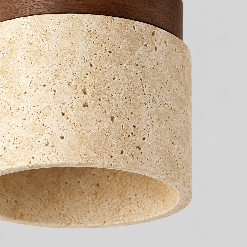 Close up of the lower rim of the cylindrical travertine shade of the cylindrical travertine flush mount ceiling light in walnut finish.