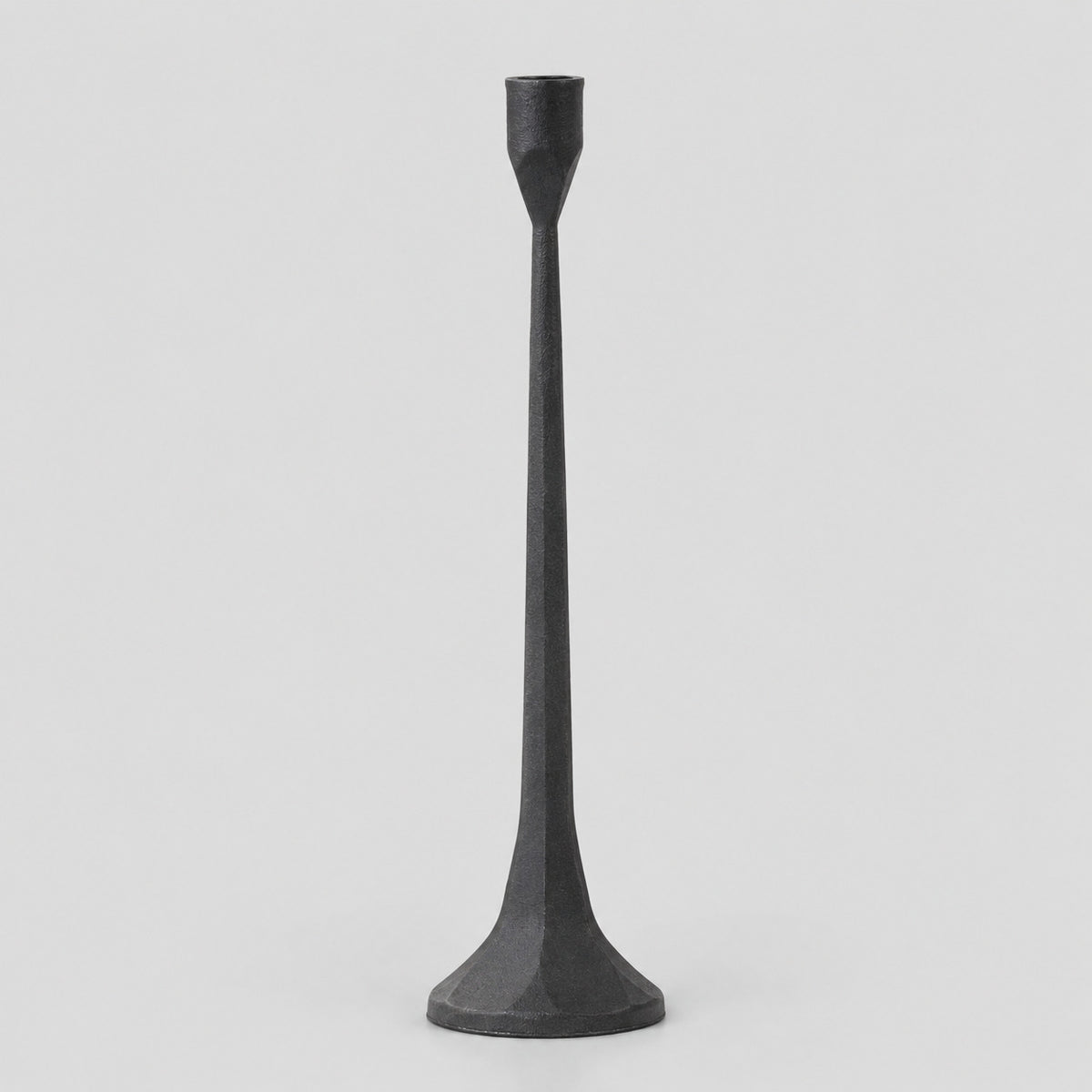 Cast iron taper candle holder in Matte Black on a light gray studio background.