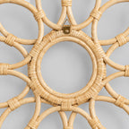 Close up of the tight rattan binding wrapped around the inner circular rim of the decorative looped rattan wall frame in Natural Rattan.