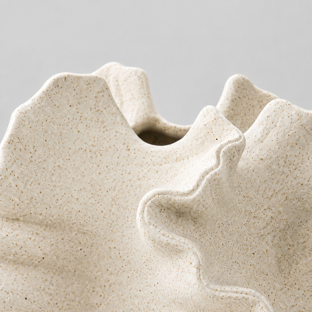 Close up of the undulating ruffled rim along the top opening of the vase in Speckled White