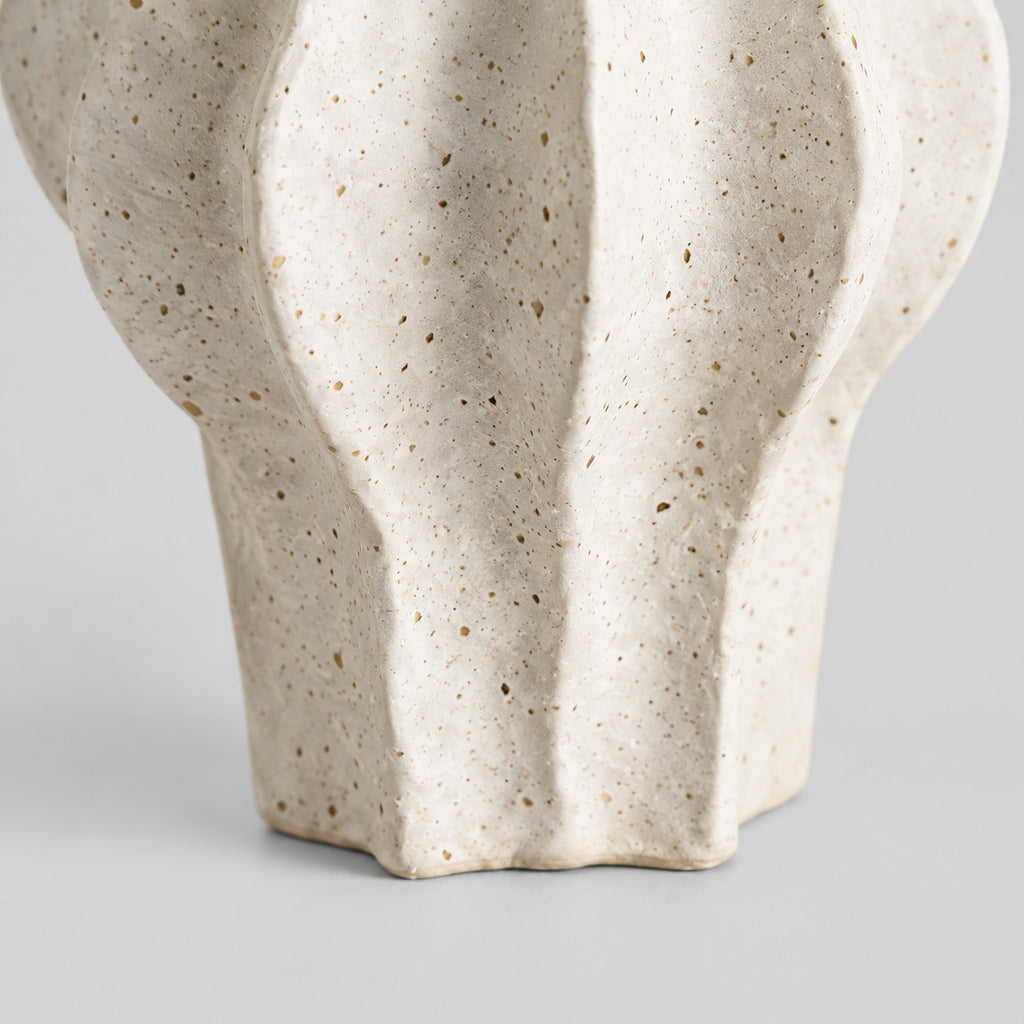 Close up of the scalloped unglazed base and foot of the coarse ceramic vase in Speckled White.