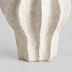 Close up of the scalloped unglazed base and foot of the coarse ceramic vase in Speckled White.