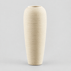 Tall ribbed stoneware vase in off-white on a light gray studio background.