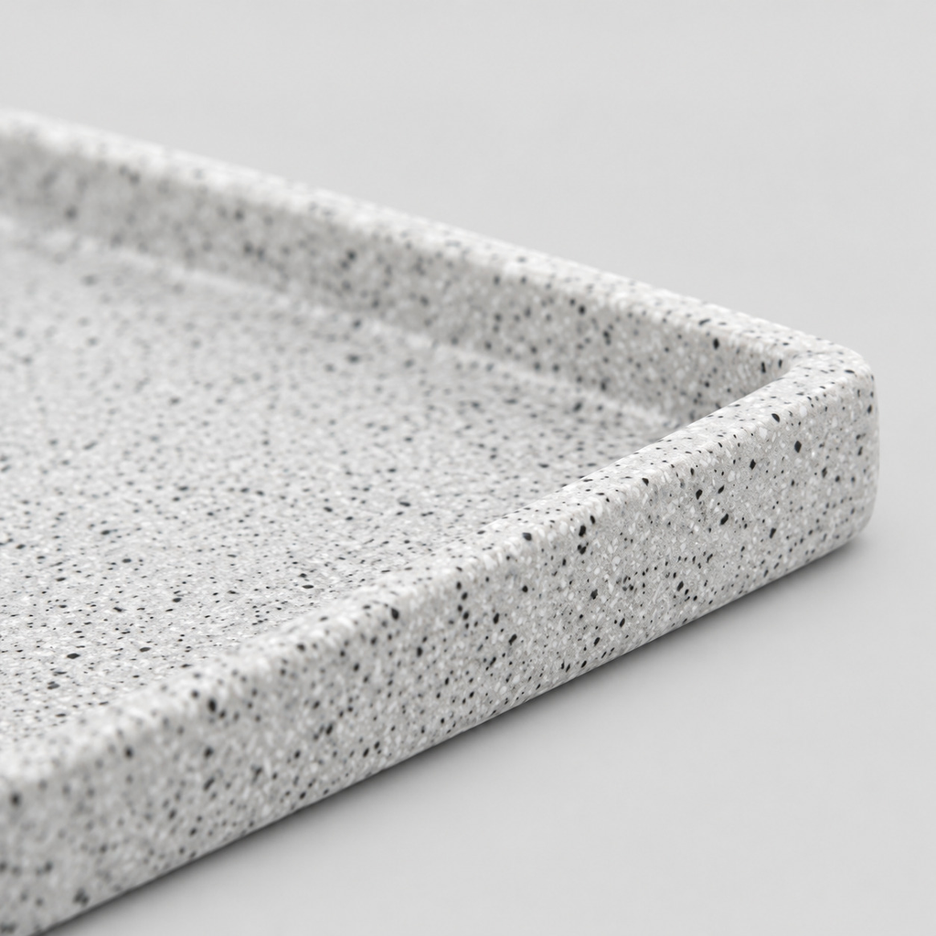 Close up of the smooth raised rim along the tray edge of the speckled ceramic catchall tray in Speckled White.