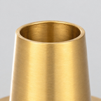 Close up of the smooth circular rim of the candle cup of the brass taper candle holder
