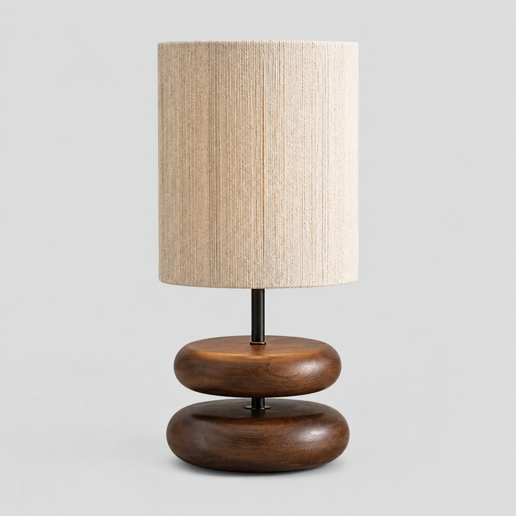 Walnut stacked wood table lamp on a light gray studio background