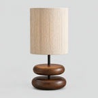 Walnut stacked wood table lamp on a light gray studio background
