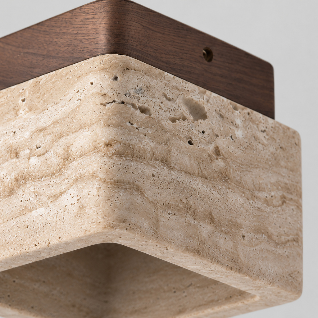 Close up of the rim where the travertine shade meets the solid wood base of the walnut ceiling light.