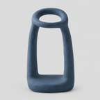 Sculptural ceramic candle holder in Matte Blue on a light gray studio background.