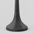 Close up of the flared faceted base of the cast iron taper candle holder in Matte Black.