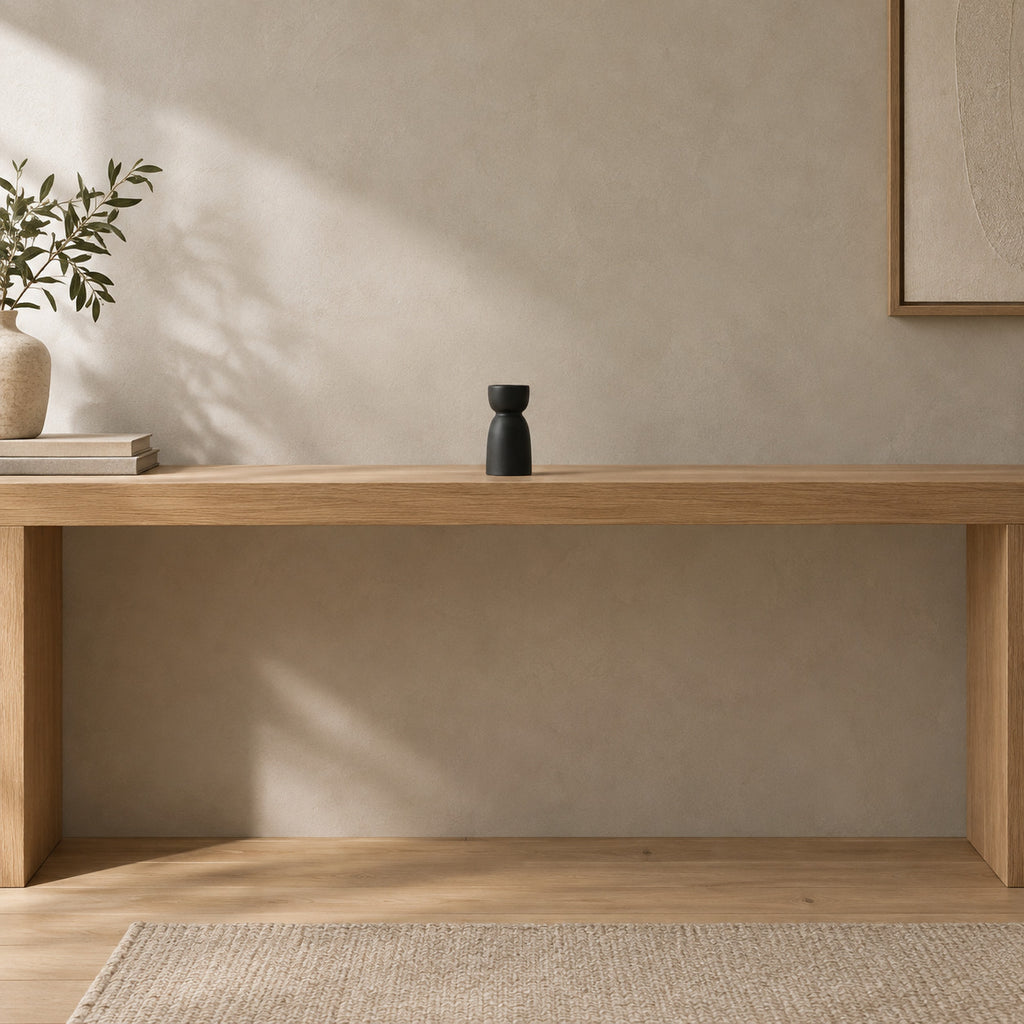 Matte ceramic taper candle holder on a 120 cm wide oak console table in a calm room.
