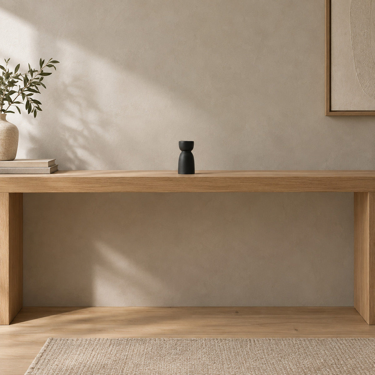 Matte ceramic taper candle holder on a 120 cm wide oak console table in a calm room.