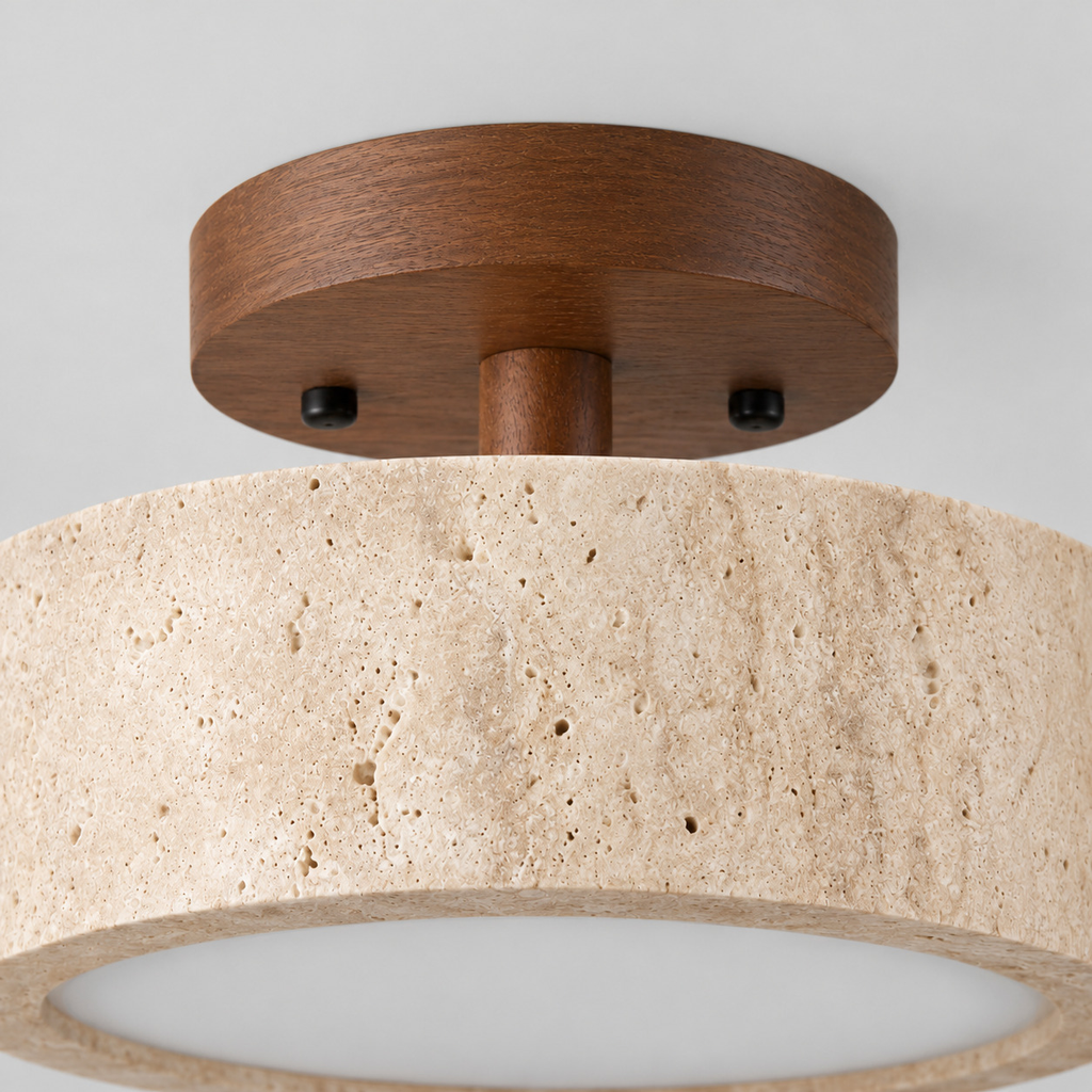 Close up of the round canopy against the wall of the travertine drum flush mount ceiling light