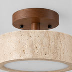 Close up of the round canopy against the wall of the travertine drum flush mount ceiling light