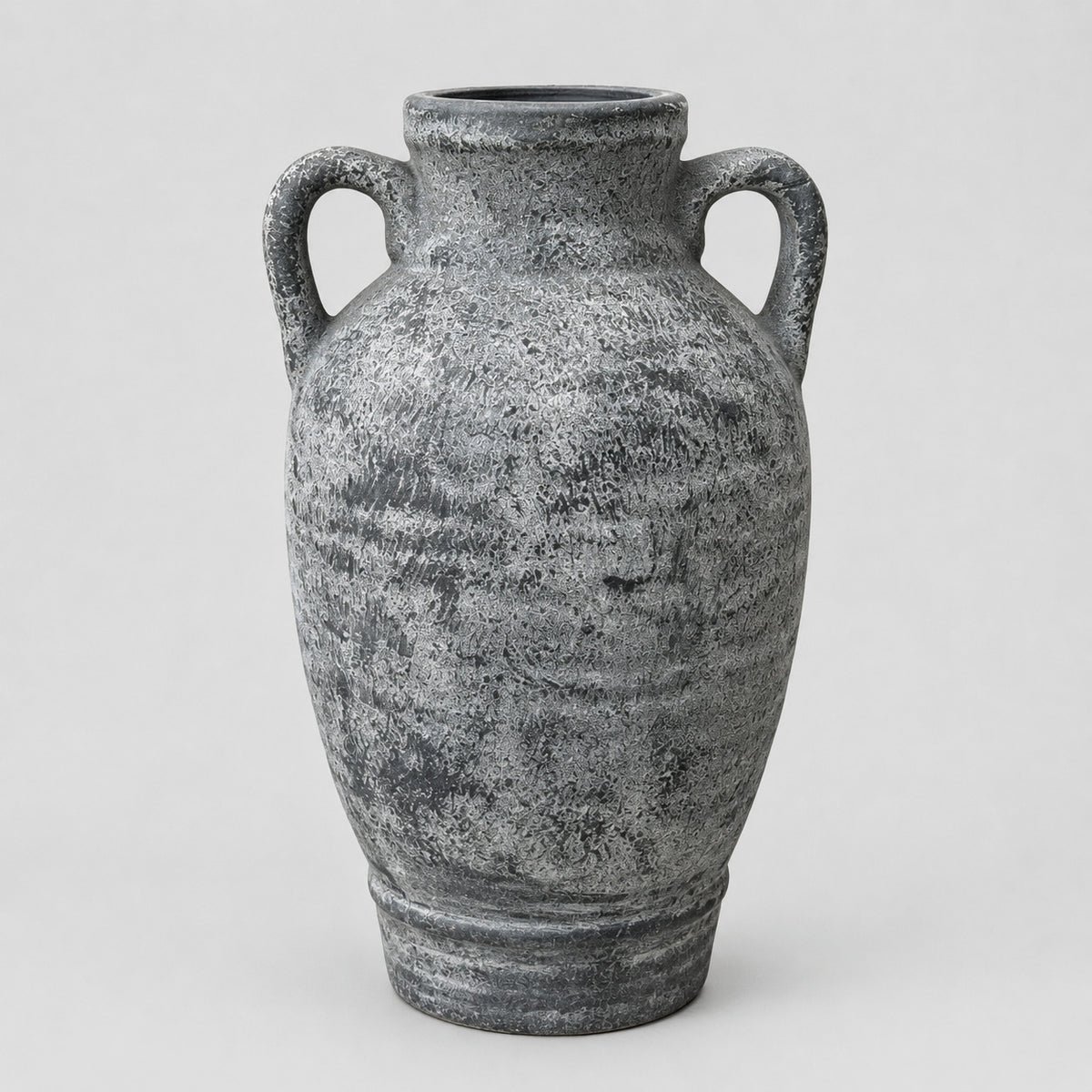 Weathered gray ceramic amphora vase on a light gray studio background