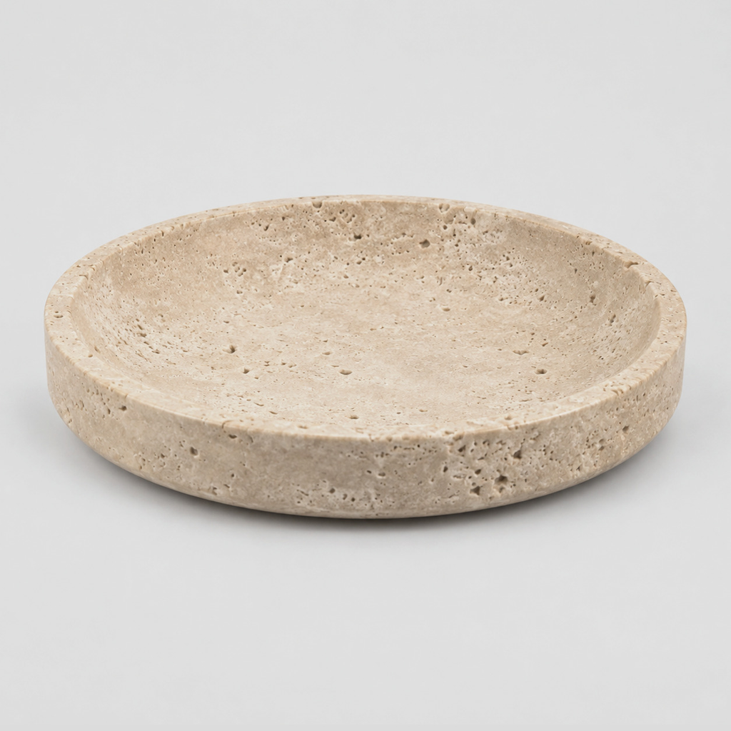 Round beige travertine dish in Beige Travertine on a light gray studio background